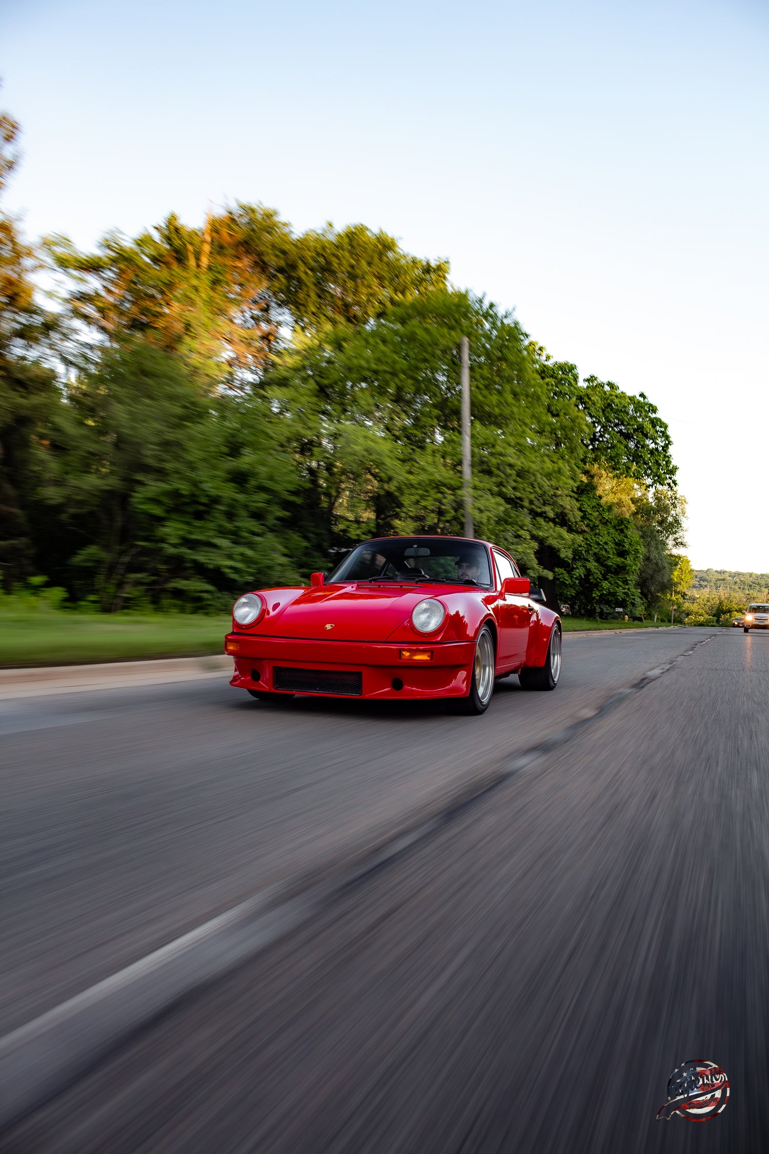 Red Porsche driving on a road 